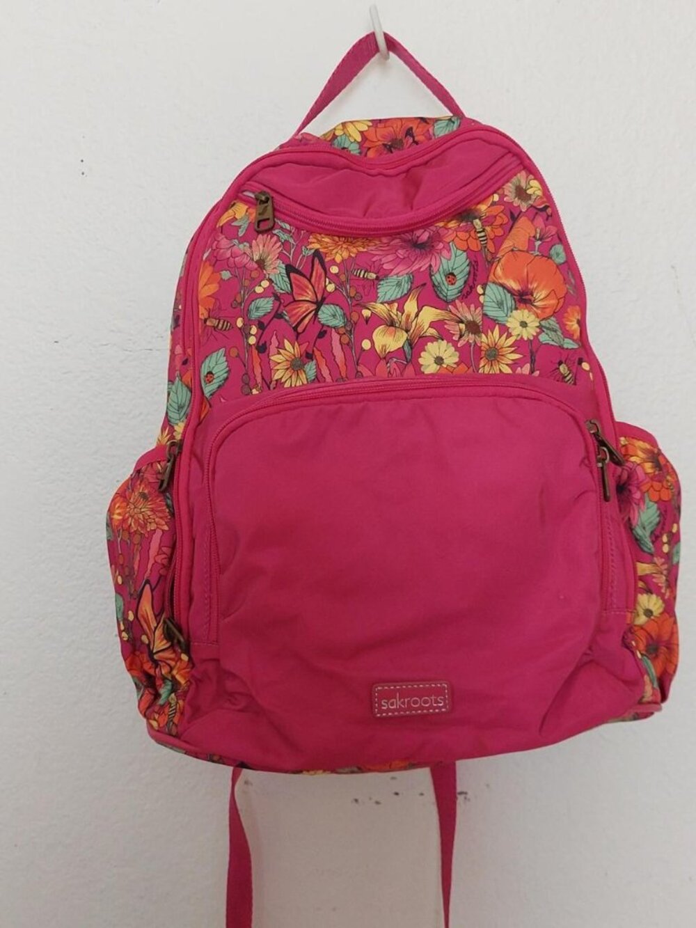 Sakroots Madison Nylon Backpack features a bright floral pattern and durable nyl